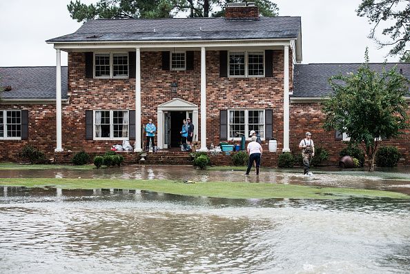 A family cleans up floodwater damage in Columbia, South Carolina.