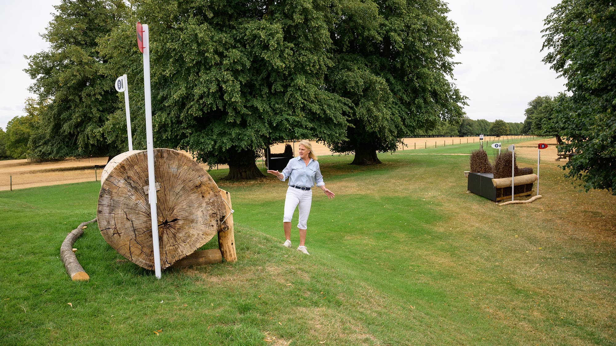 Event rider Tina Cook looks back at a log fence, with a corner fence in the background, on the Burghley cross-country course 2026