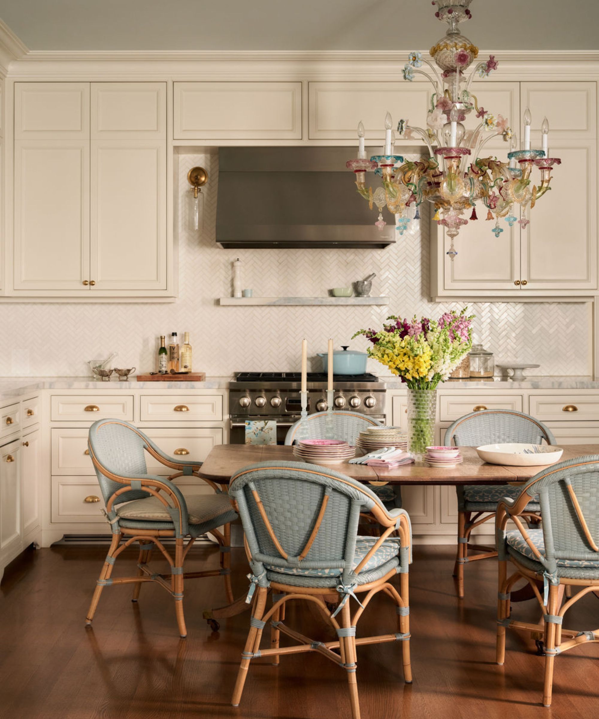 a neutral traditional kitchen with a blue painted ceiling murano chandelier and vintage table and chairs