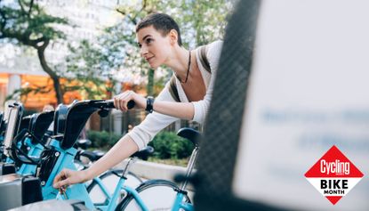 A woman checking out a bike share bike
