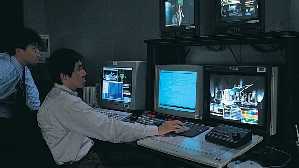 Two developers look at a blue monitor