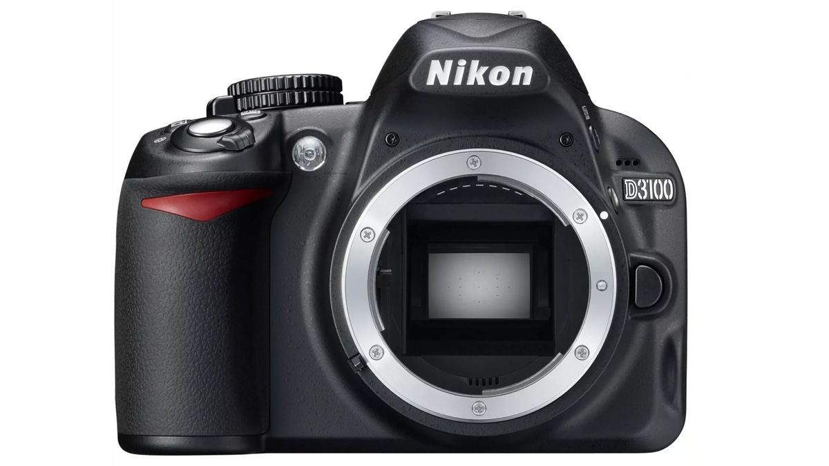 Front view of a Nikon D3100 camera with a sleek black body and lens mount, featuring buttons and a textured grip