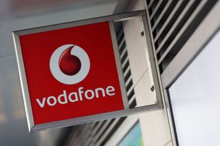 The Vodafone logo on a sign outside a shop