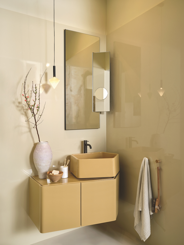 mustard yellow washbasin mounted on a matching cabinet