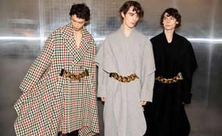 3 male models in a studio wearing long coats