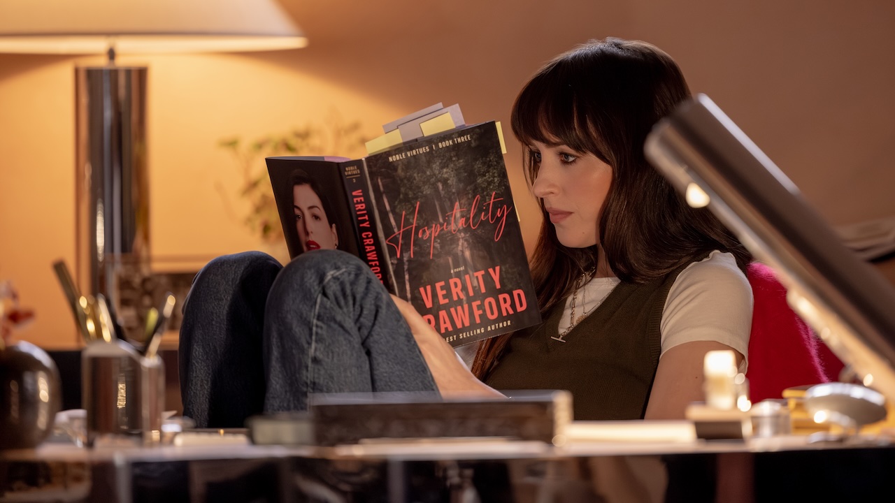 Dakota Johnson reading a book in Verity