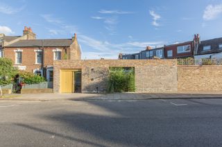 brick wall of triangle house by brown urbanism