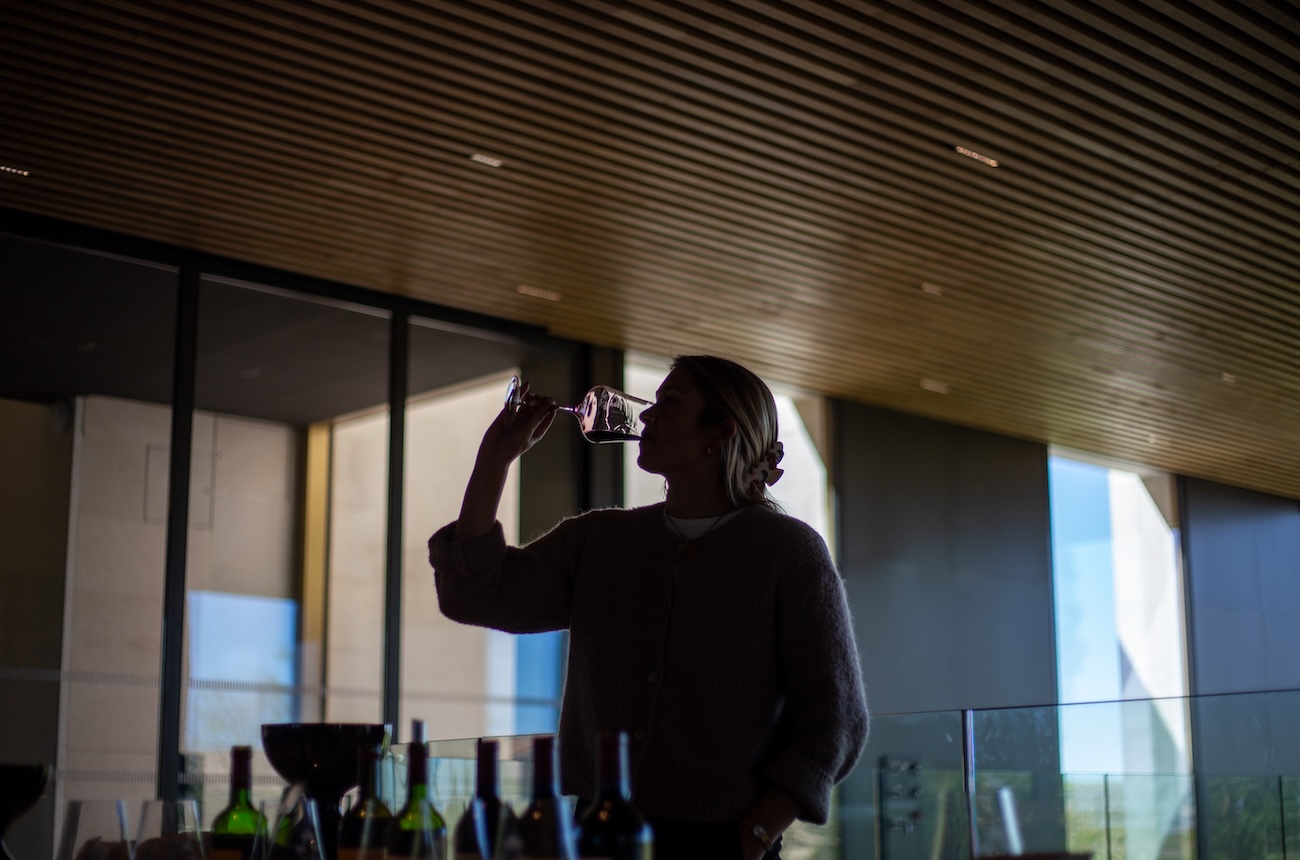 Lady tasting wine in cellar
