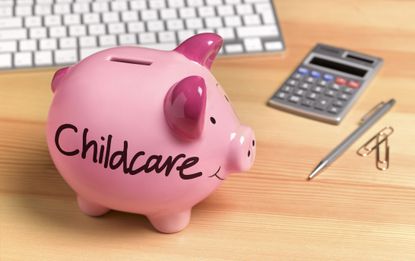 Childcare written on piggy bank on a wood surface with a calculator
