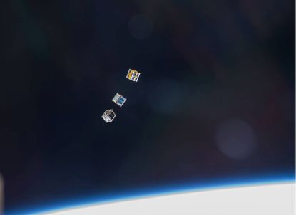 Three nanosatellites, known as Cubesats, are deployed from a Small Satellite Orbital Deployer (SSOD) attached to the Kibo laboratory&rsquo;s robotic arm in 2013.