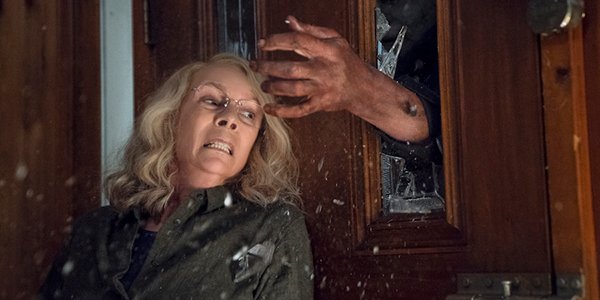 Michael Myers trying to grab Laurie Strode through a door