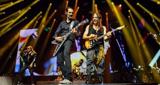  (L-R): Fher Olvera (Mana), Cesar Gueikian (Gibson CEO) playing the Gibson Flying V Custom CEO#8, and Sergio Vallin (Mana), performing onstage with Mana at Bridgestone Arena. 