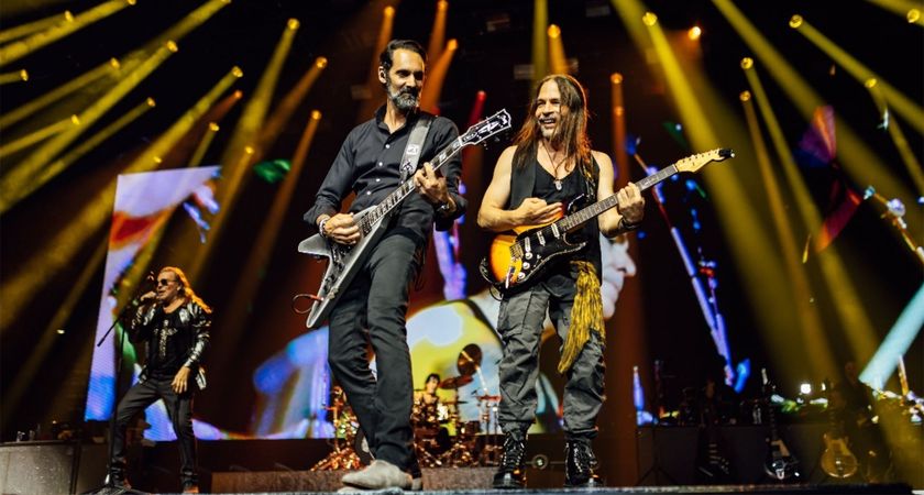  (L-R): Fher Olvera (Mana), Cesar Gueikian (Gibson CEO) playing the Gibson Flying V Custom CEO#8, and Sergio Vallin (Mana), performing onstage with Mana at Bridgestone Arena. 