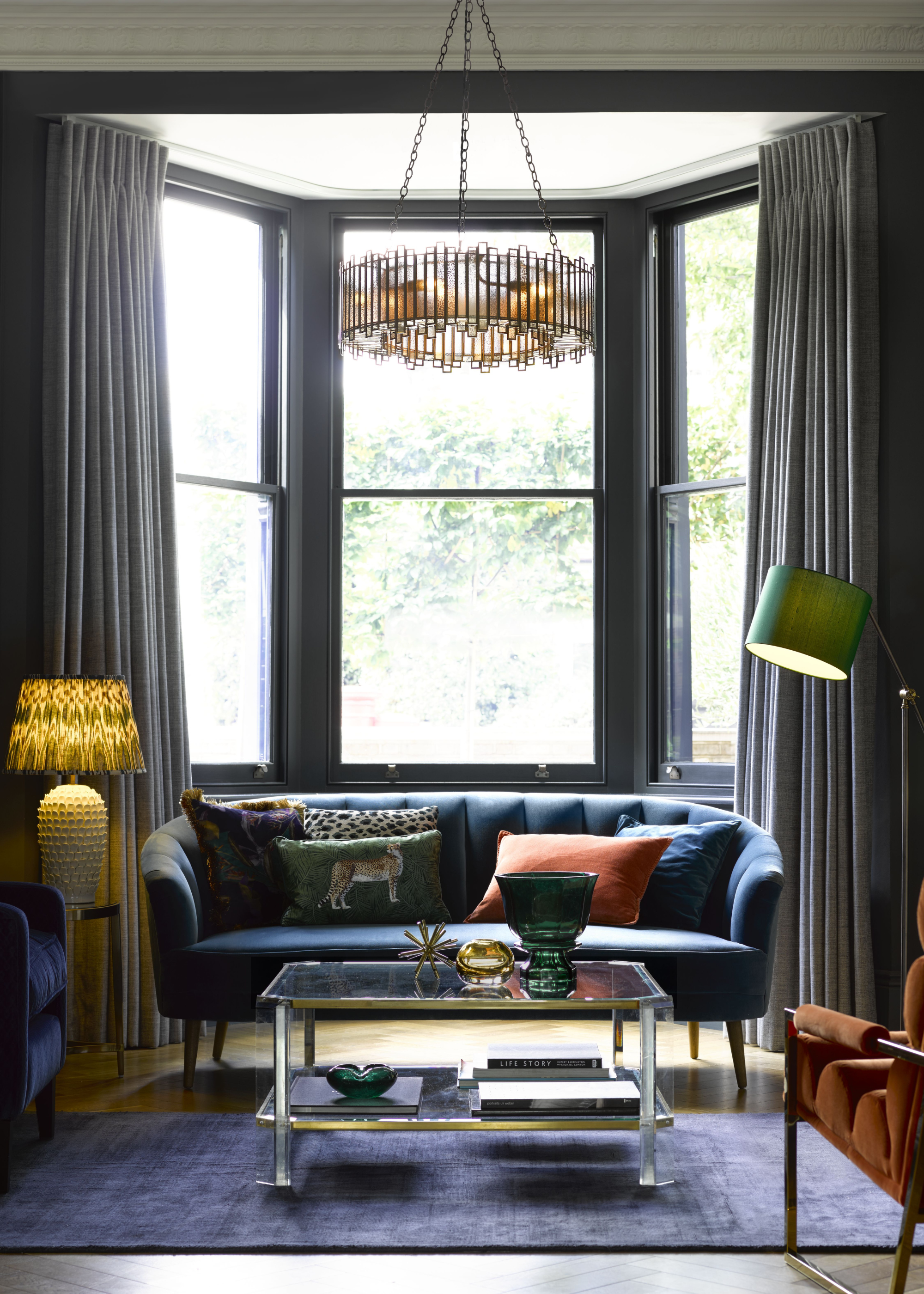 cozy and traditional living room with lamps and a chandelier