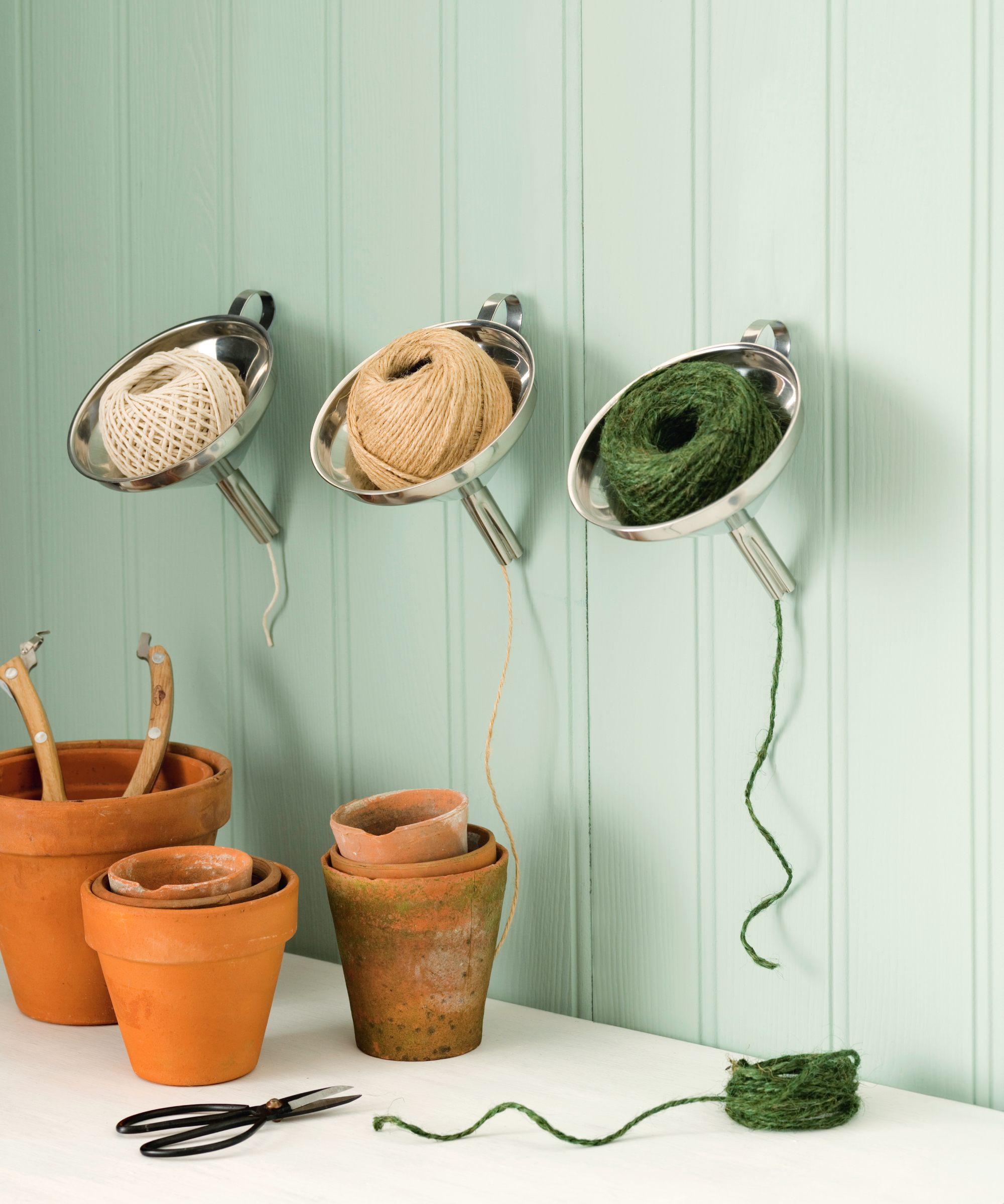 Gardening twine dispenser. Stainless steel funnels, wall mounted containing garden twine