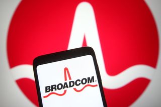 Broadcom name and logo on a phone in front of a large Broadcom logo