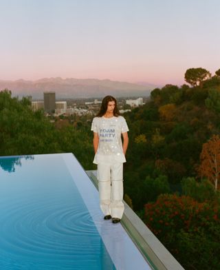 Man stood by pool in Californian wearing 'Foam Party' T-shirt