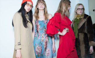 Female models wearing floral, camel and red clothes from the A/W 2015 collection