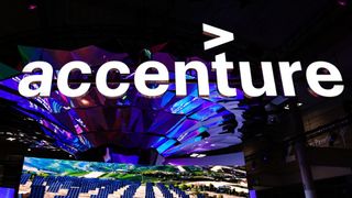 An Accenture sign displayed at a conference above an image showing rows of solar panels