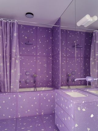 A bathroom with purple tiles
