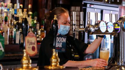 Barmaid pouring a pint