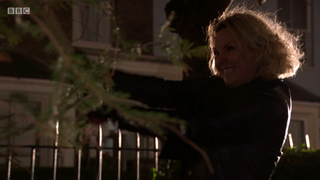 Janine Butcher cuts down the Christmas tree with an axe