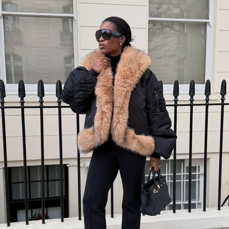 @nlmarilyn wearing a fur-trimmed coat with Tom Ford aviator sunglasses