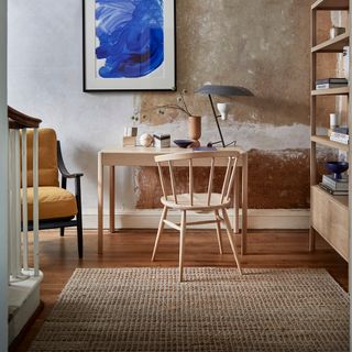 home office with white and brown wall wooden desk and chair frame on wall wooden flooring