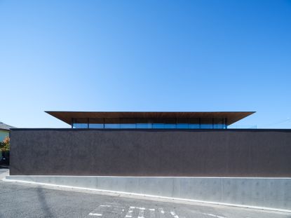 an Osaka house by apollo architects & associates featuring a dramatic roof and double height interiors