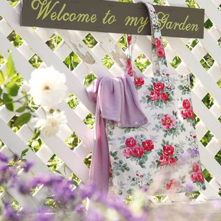 white trellis fence with flora cloth bag