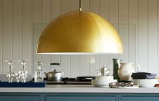 large yellow gold dome pendant lighting over a kitchen island