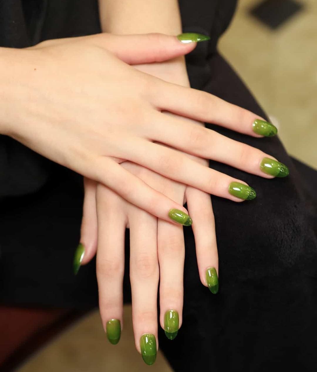 Person with olive green jelly nails.