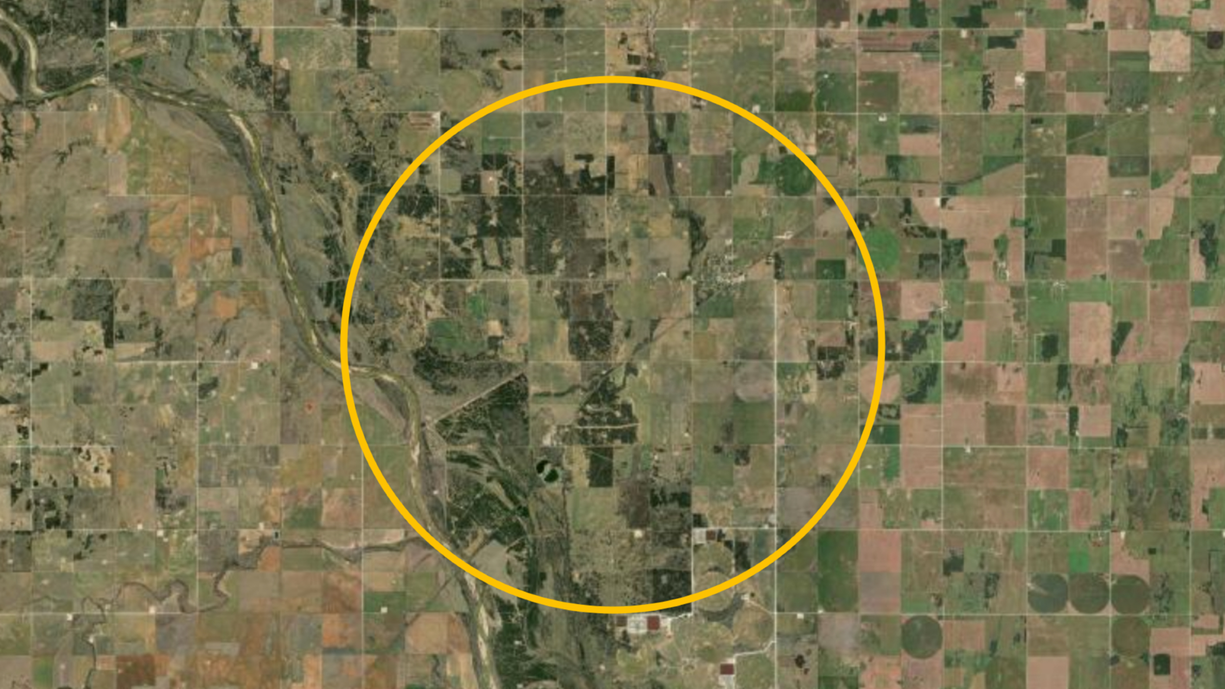 A satellite photo of the Oklahoma countryside with a large orange circle highlighting the location of the buried Ames crater