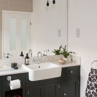 bathroom with drawers and towel rails
