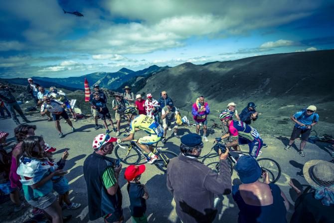 On the summit of the Port de Bales. Stage winner Michael Rogers Tinkoff Saxo Bank ahead of Lampre J R Serpa and Thomas Voeckler team Europcar.