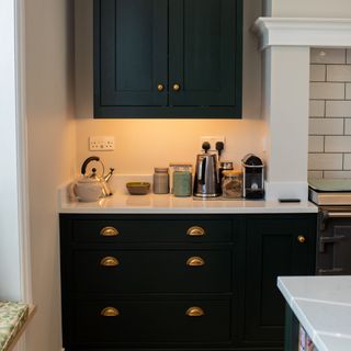 coffee corner in kitchen with dark green cabinets