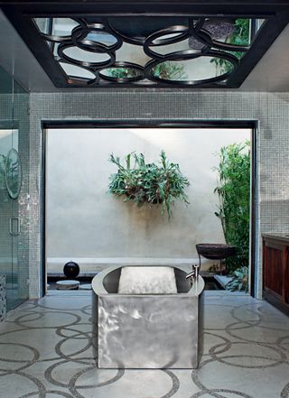 Silver bathroom with central bath tub