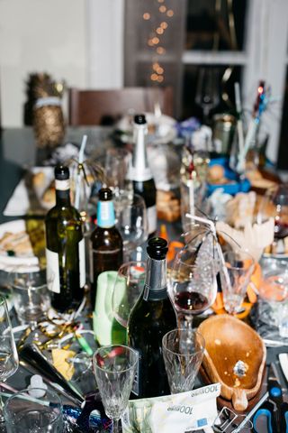 Table Full of Empty Alcohol Bottles & Glasses