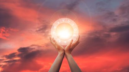 Mercury retrograde in Aquarius 2022: Zodiac signs inside of horoscope circle in woman hand at sunset. Astrology and horoscopes