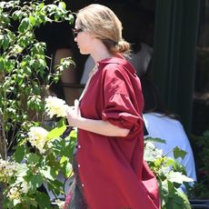 Jennifer Lawrence walks in Manhattan wearing a burgundy button down shirt and floral skirt with the mary janes trend