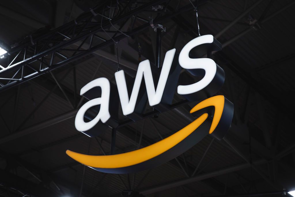 An illuminated AWS sign hanging from the ceiling of a conference center