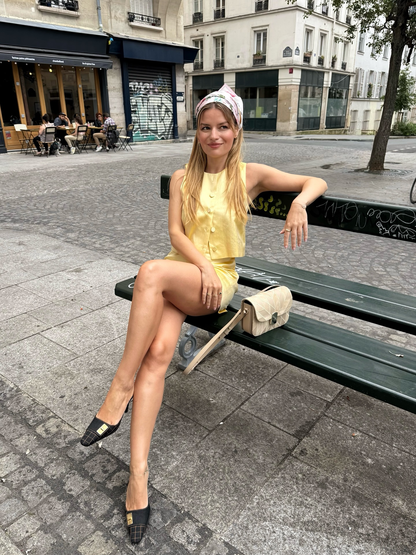 Sabina Socol wearing Chanel mules with a yellow co-ord and headscarf