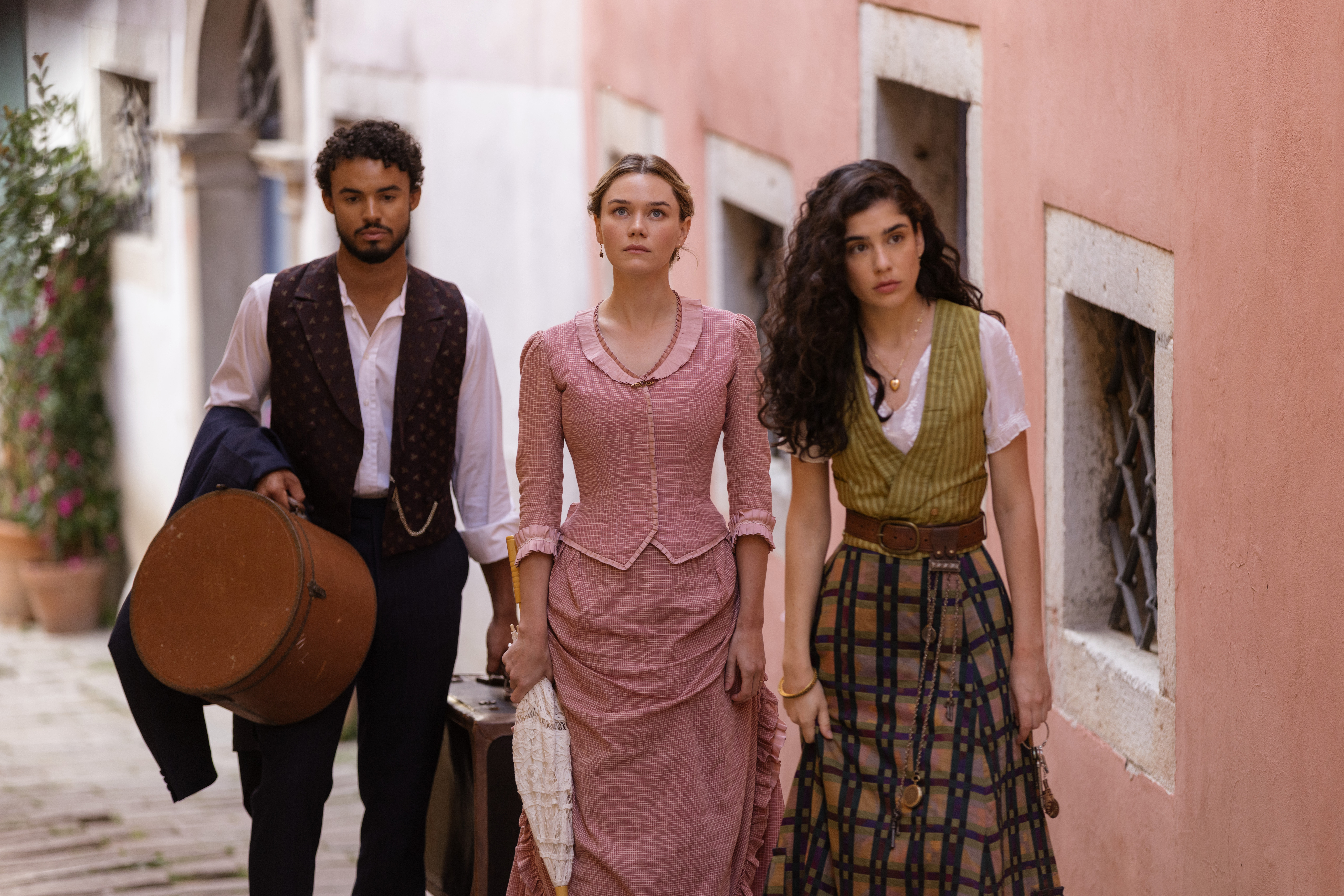 Matthew Broome, Imogen Waterhouse and Grace Ambrose in The Buccaneers season 2 walking up a hill