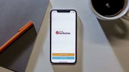 picture of cell phone on table showing TurboTax sign in page
