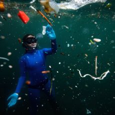 Freediver swimming in polluted water