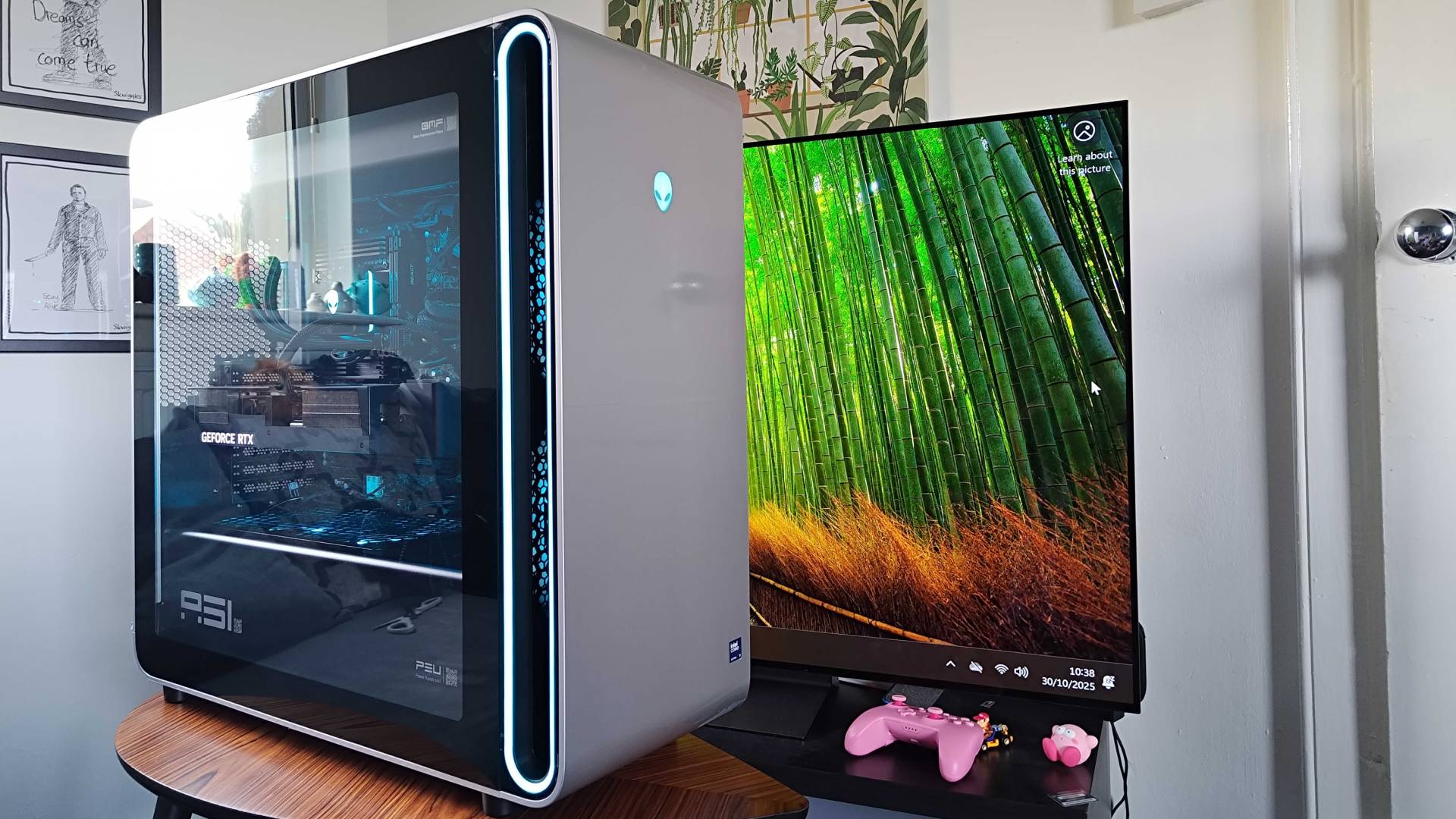 Alienware Area-51 gaming PC on coffee table with TV in in backdrop.