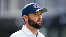 Scottie Scheffler with a USA hat on indicating his love of America and hinting at his reticence to leave 