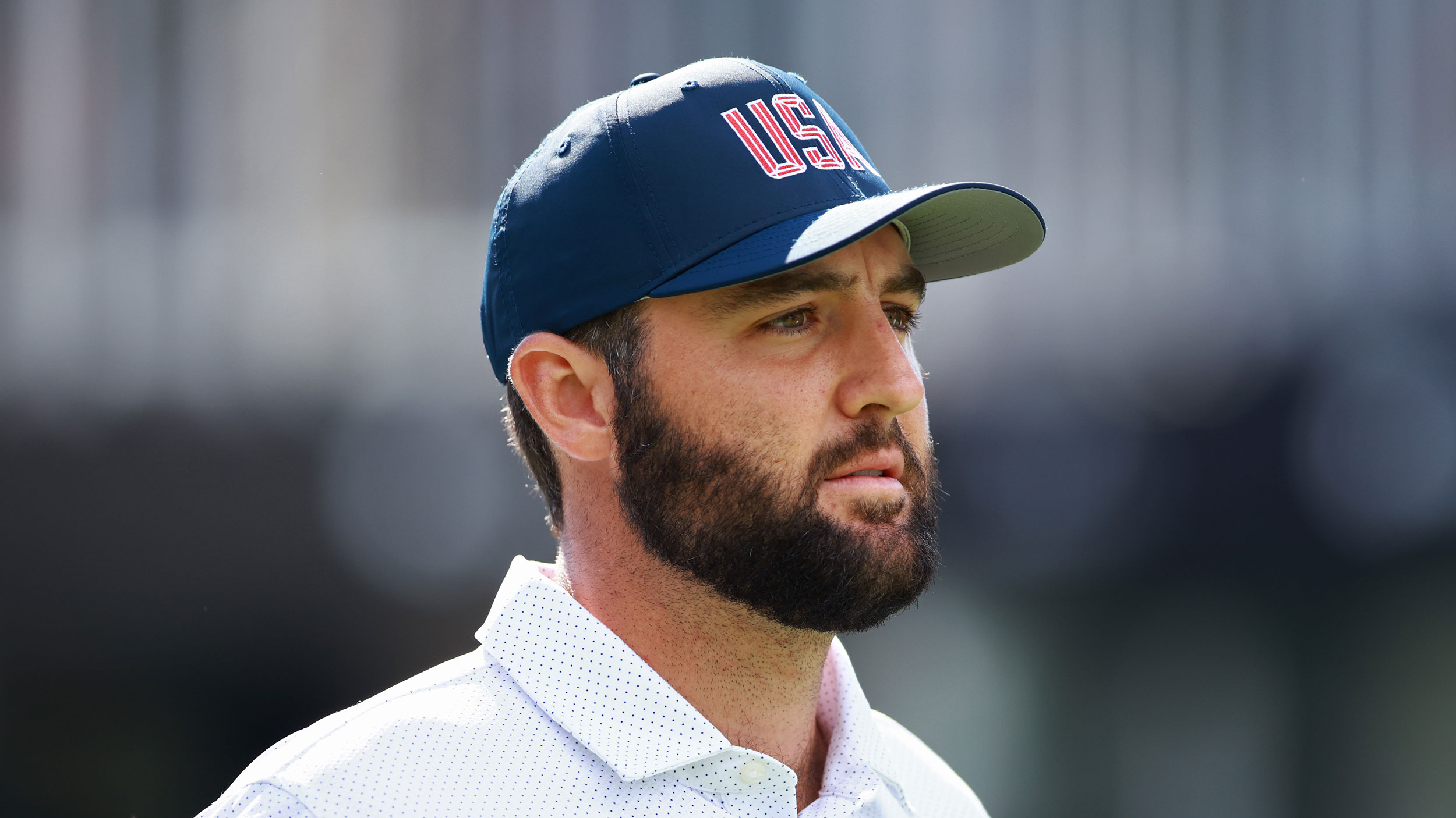 Scottie Scheffler with a USA hat on indicating his love of America and hinting at his reticence to leave 