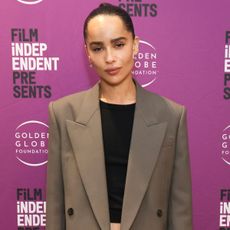 Zoe Kravitz wears a brown blazer and a black T-shirt