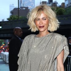 Nicole Ari Parker with a short blonde bob and dark purple lipstick